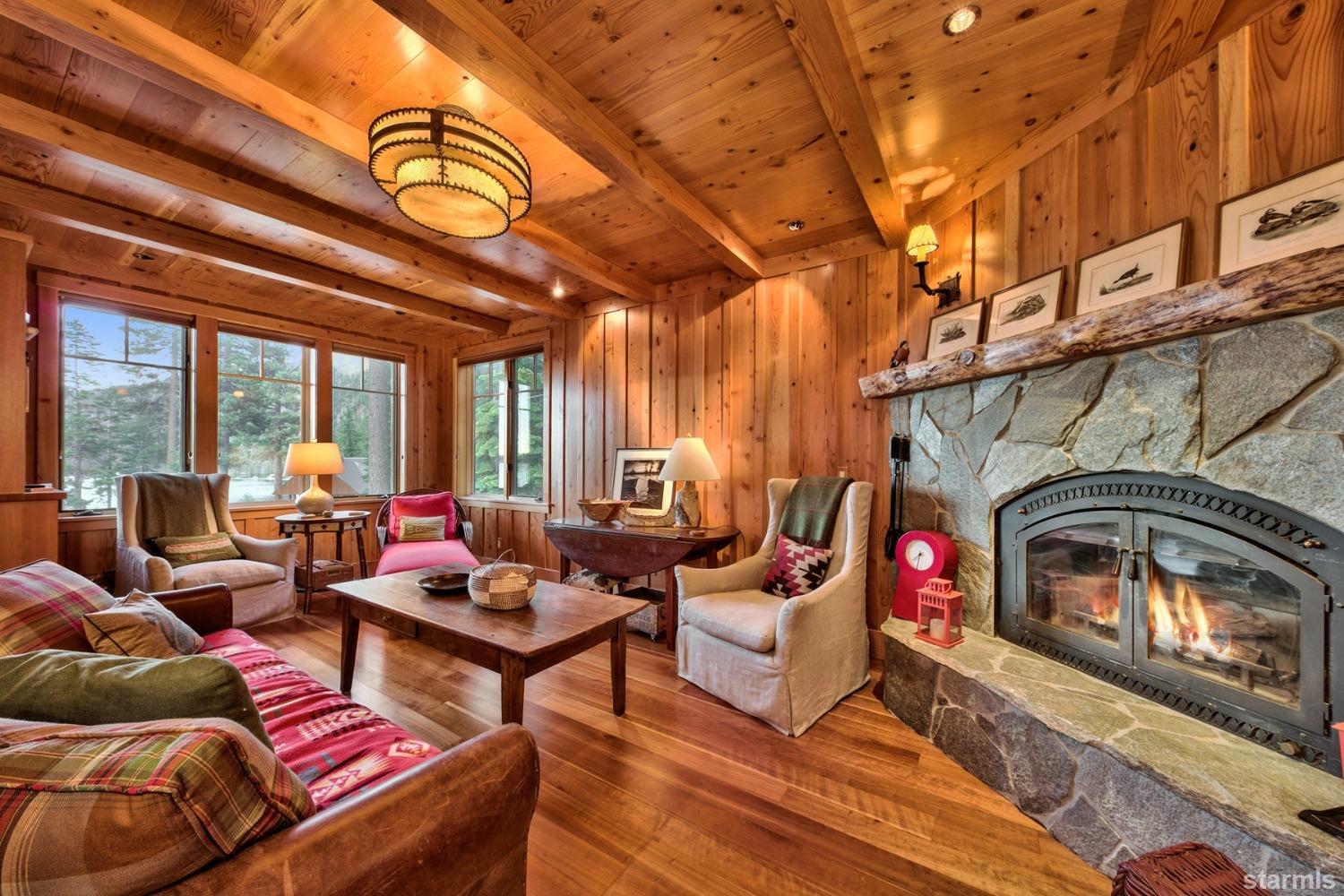 373 Fallen Leaf Road Fallen Leaf, CA 96150 - Photo 6 of 40 a living room with furniture a fireplace and a floor to ceiling window
