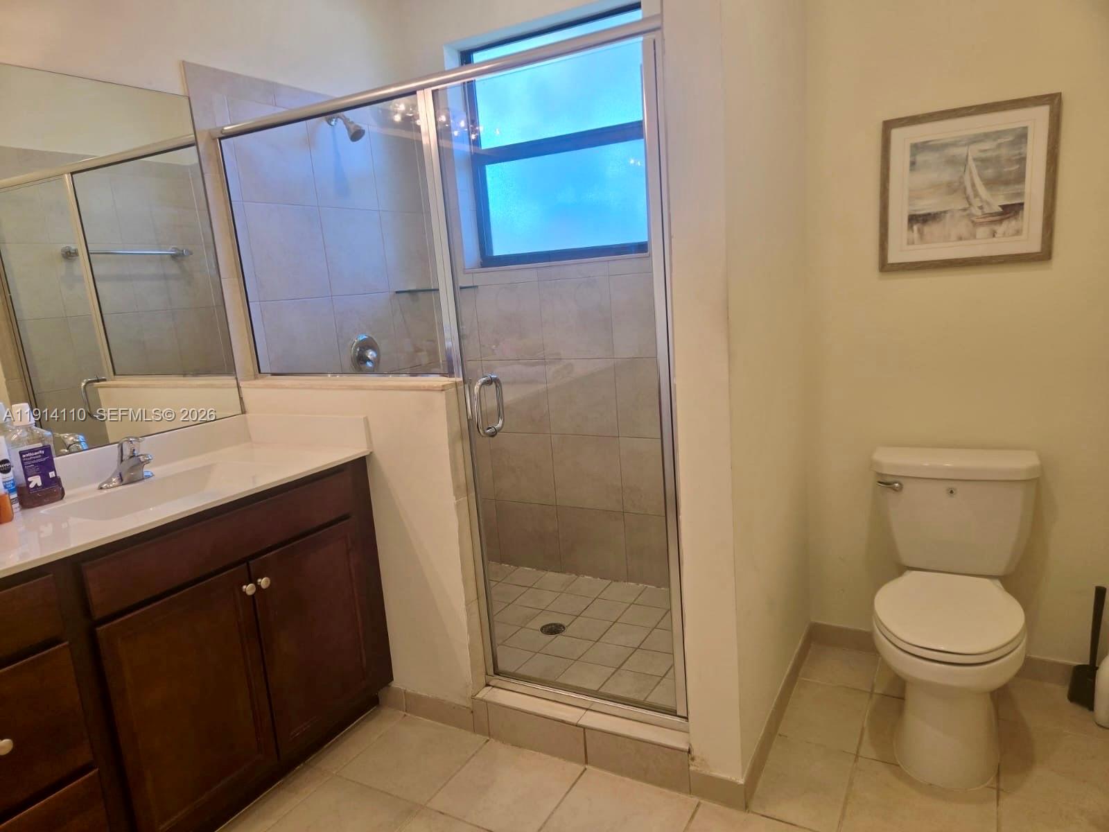 110 Southeast 33rd Terrace Homestead, FL 33033 - Photo 5 of 11 a bathroom with a shower sink vanity and toilet