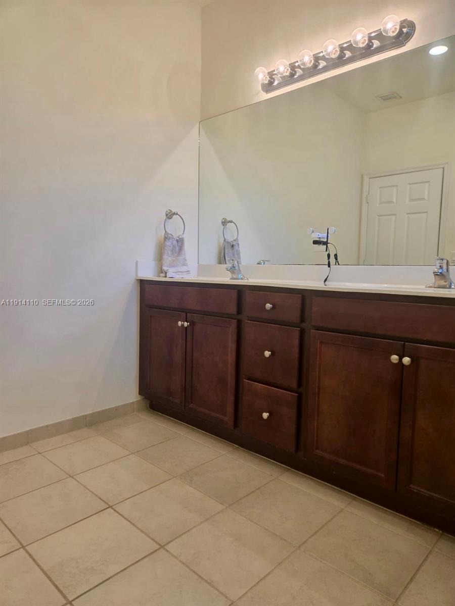 110 Southeast 33rd Terrace Homestead, FL 33033 - Photo 8 of 11 a bathroom with a sink vanity and mirror