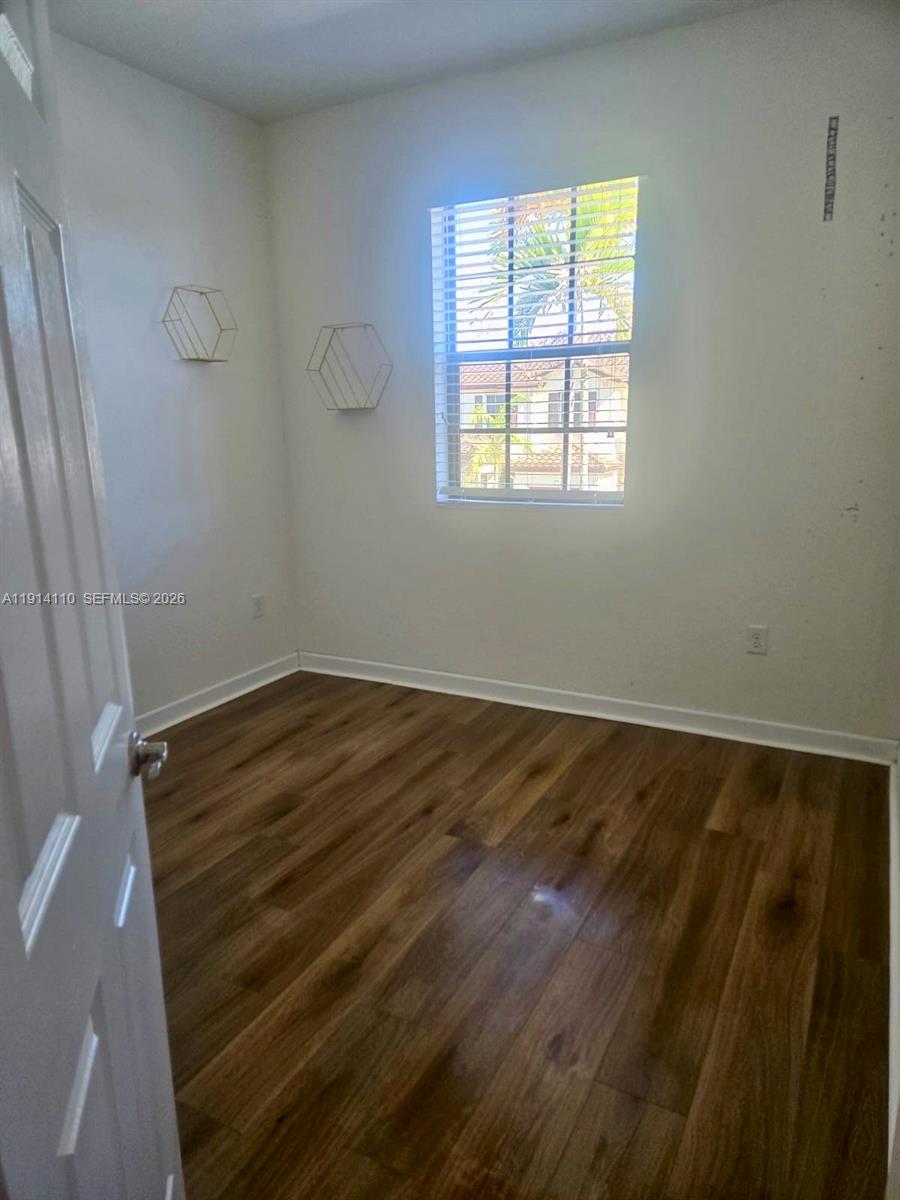 110 Southeast 33rd Terrace Homestead, FL 33033 - Photo 9 of 11 a view of room with window and hardwood floor