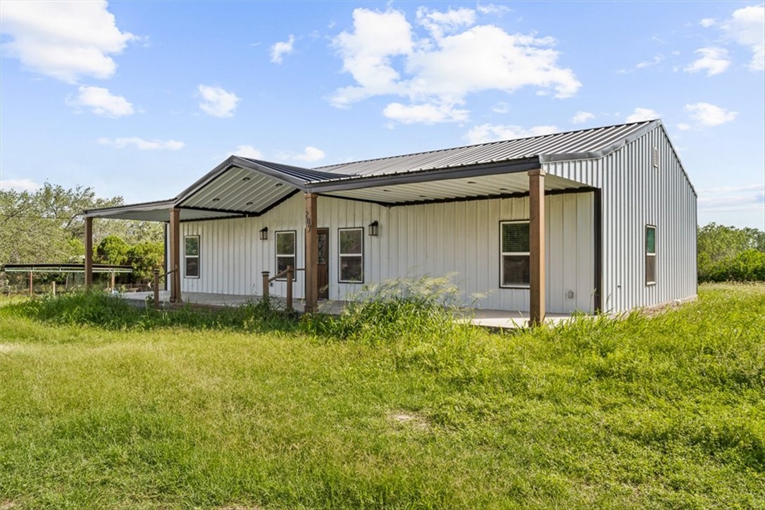 207 South Charles Street George West, TX 78022 - Photo 3 of 24 a view of a house with backyard and garden