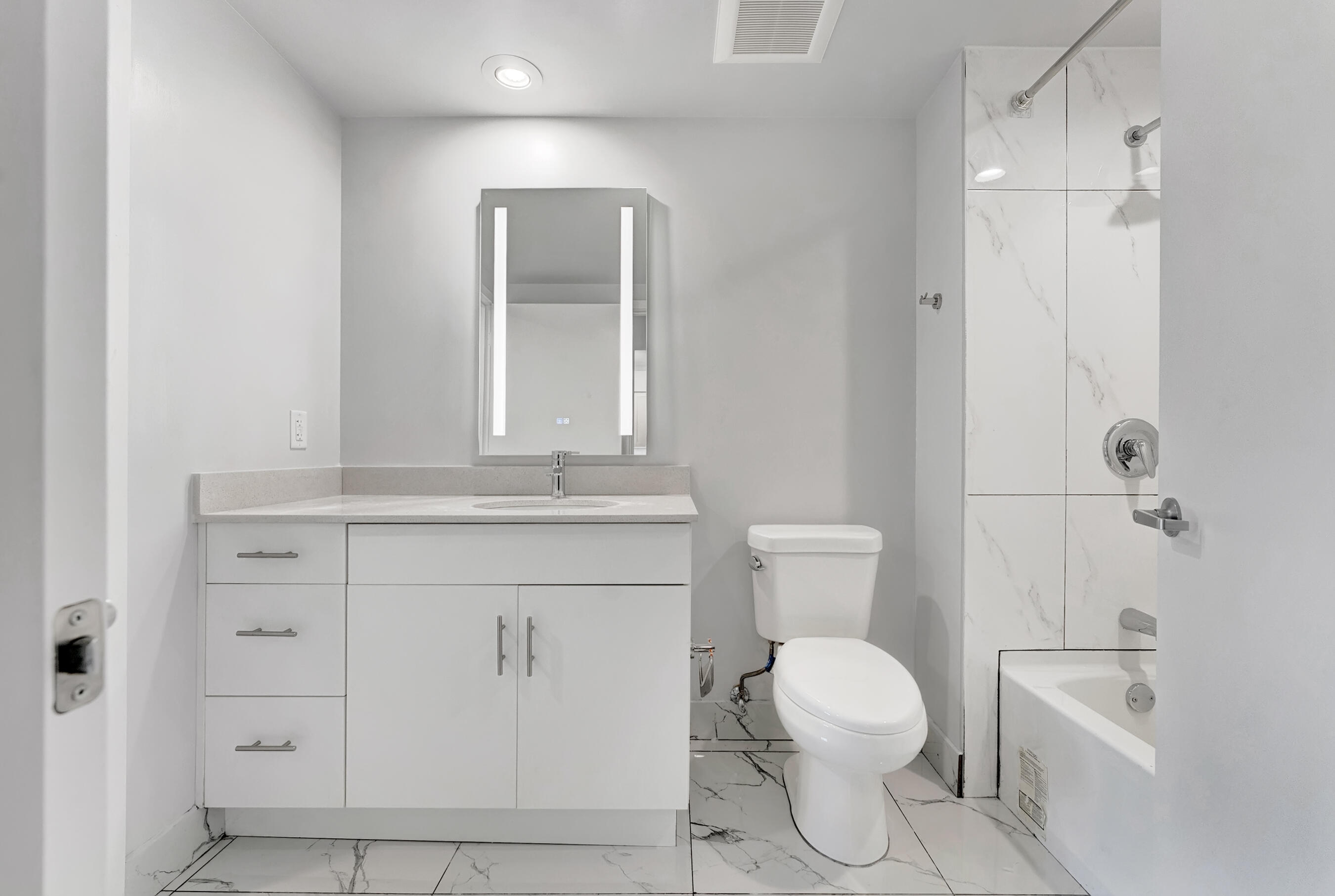 250 West Hidden Valley Boulevard, Unit 2 Boca Raton, FL 33487 - Photo 11 of 19 a bathroom with a toilet sink and mirror