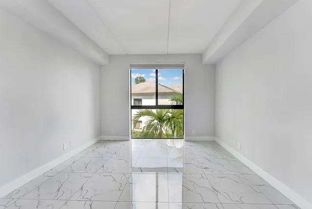 a bathroom with a granite countertop sink mirror and toilet