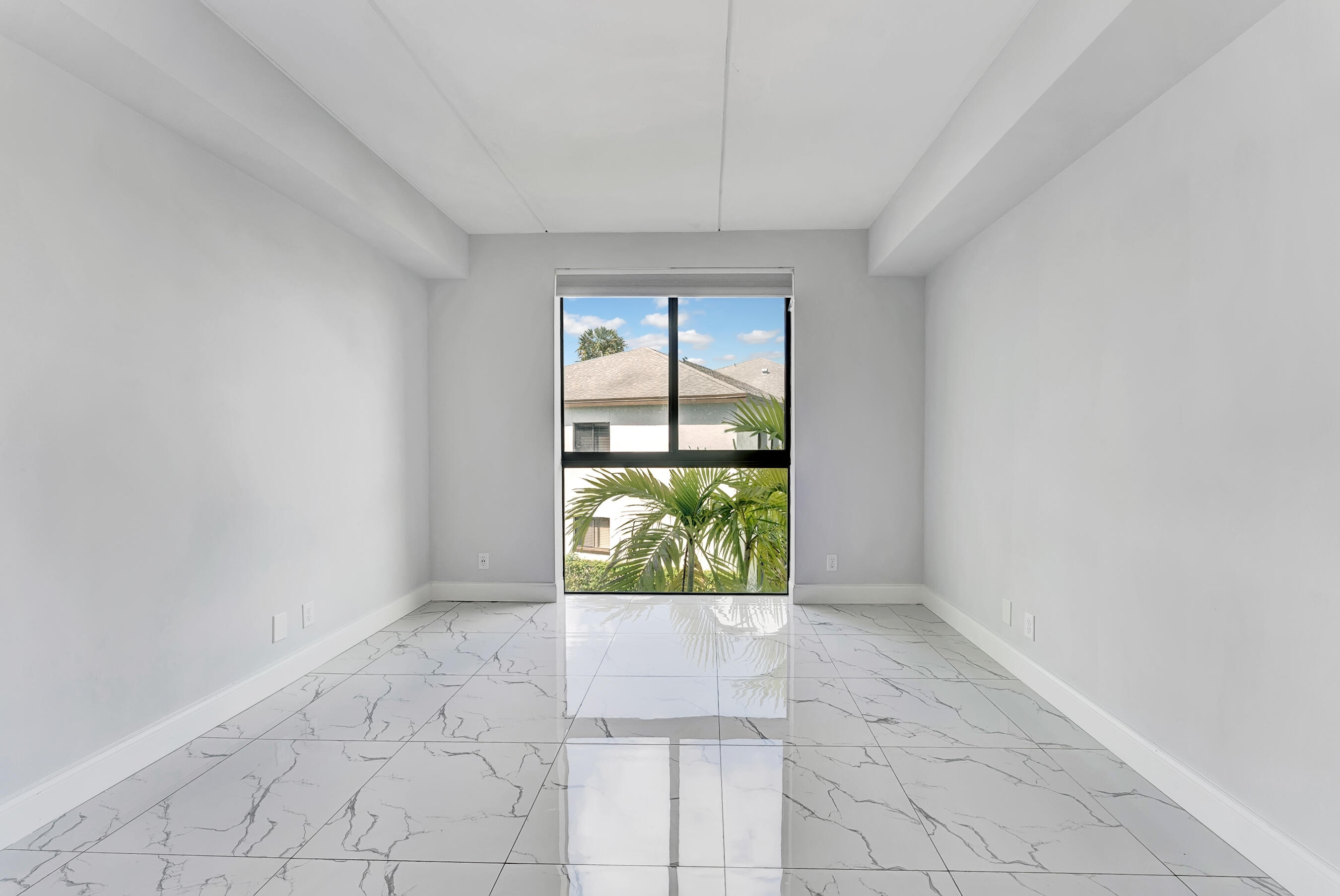 250 West Hidden Valley Boulevard, Unit 2 Boca Raton, FL 33487 - Photo 7 of 19 an empty room with windows