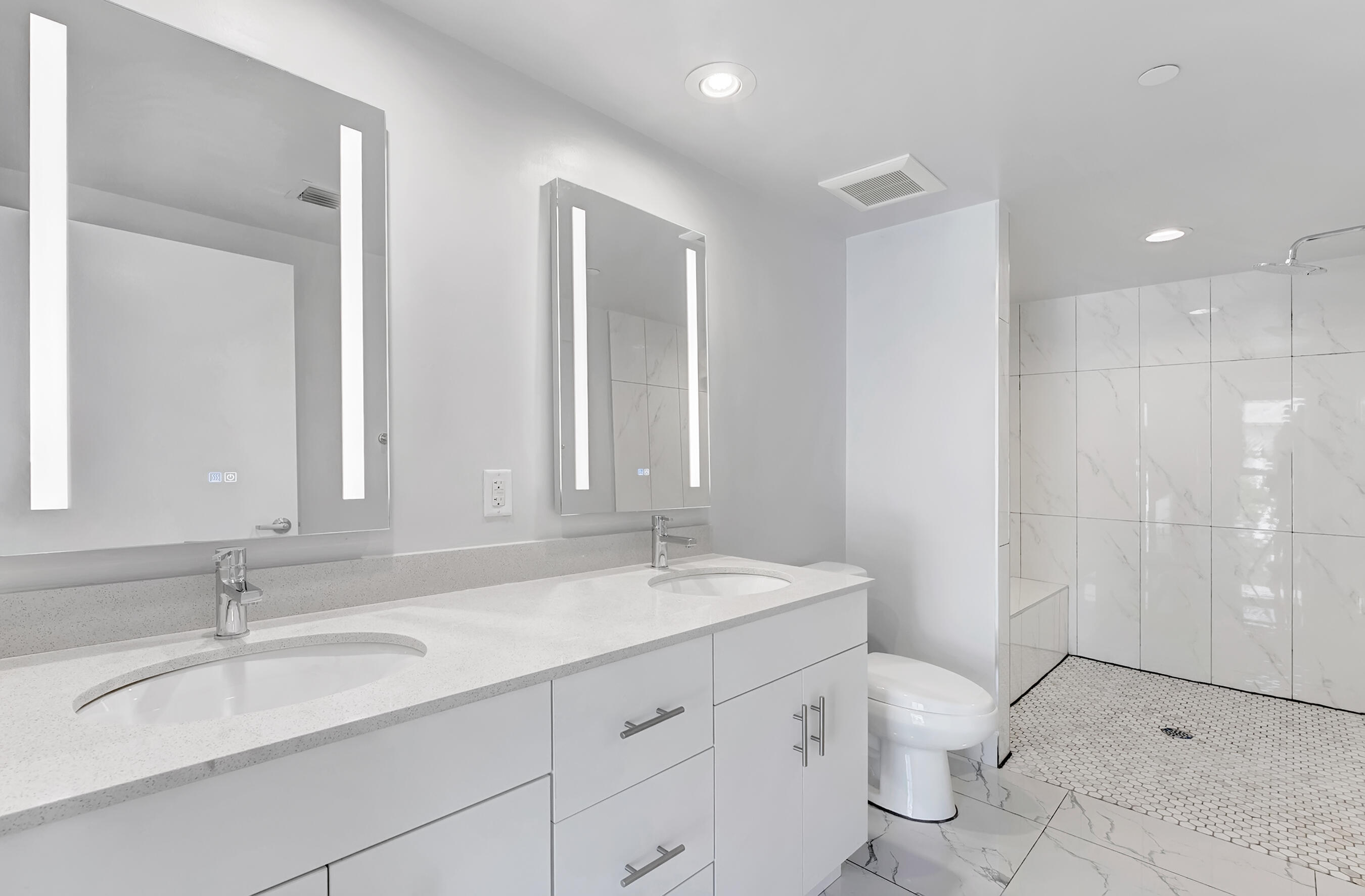 250 West Hidden Valley Boulevard, Unit 2 Boca Raton, FL 33487 - Photo 8 of 19 a bathroom with a granite countertop sink mirror and toilet