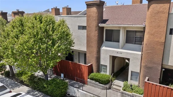 a front view of a house with plants and garden