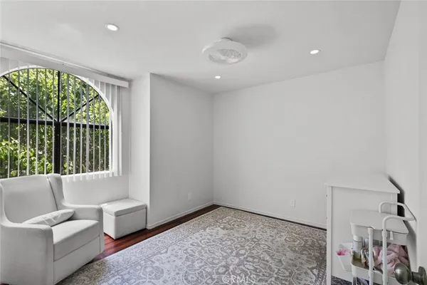 a room with a white bed and a mirror