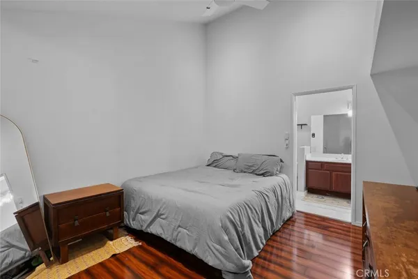a bedroom with a bed and a night stand