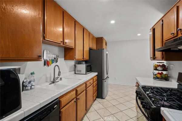 a kitchen with stainless steel appliances a sink stove and cabinets