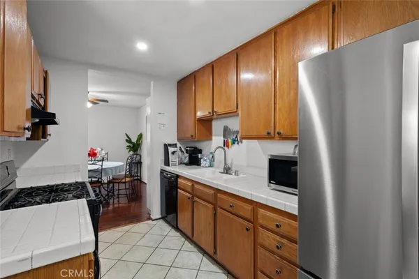a kitchen with stainless steel appliances a refrigerator sink and cabinets