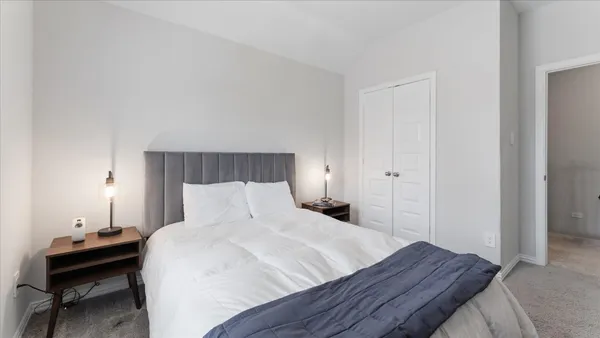 a bedroom with a bed and a table