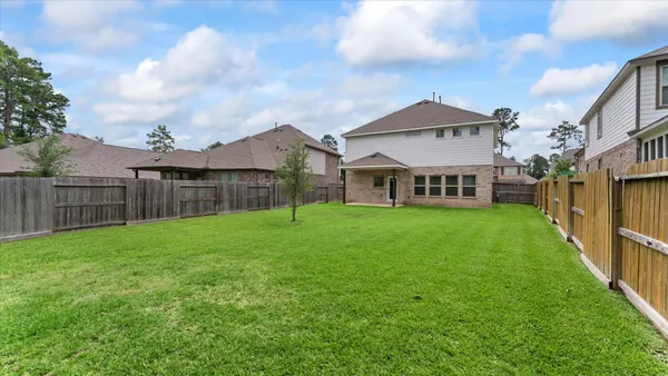 a view of a house with a yard and deck