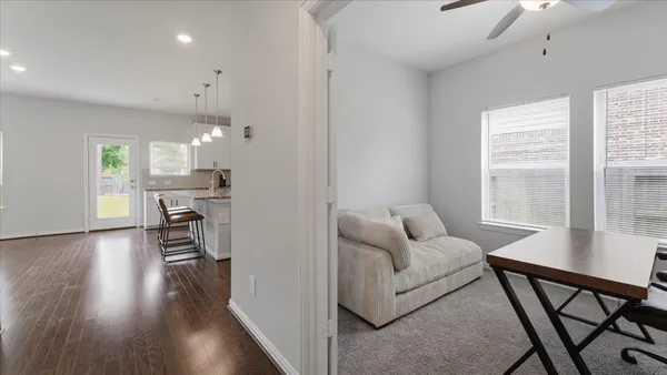 a living room with furniture and wooden floor