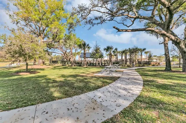 a swimming pool with outdoor seating and plants