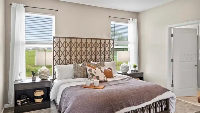 a bed sitting in a bedroom next to a window