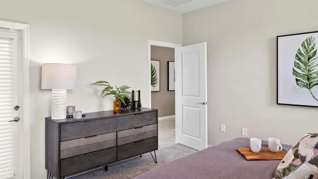 a bedroom with a bed and a potted plant