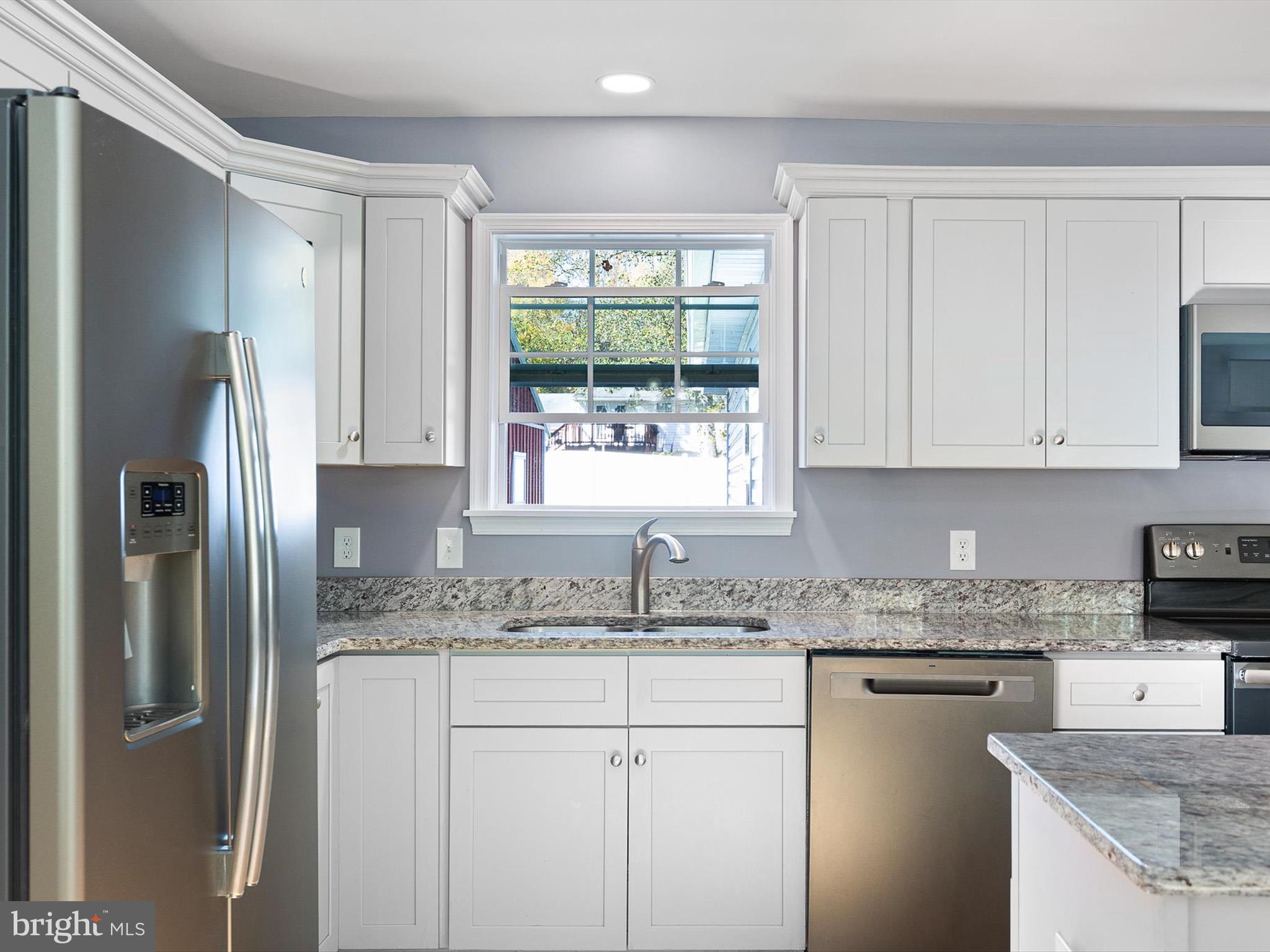 653 Mechanics Valley Road North East, MD 21901 - Photo 7 of 21 a kitchen with stainless steel appliances granite countertop a refrigerator and window