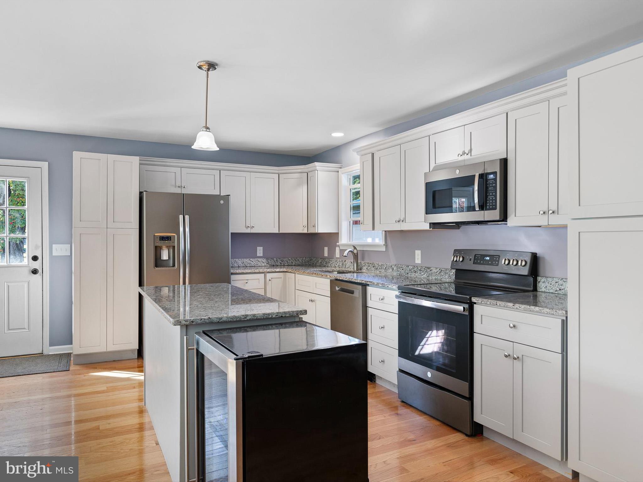 653 Mechanics Valley Road North East, MD 21901 - Photo 8 of 21 a kitchen with stainless steel appliances granite countertop a refrigerator a stove a sink a microwave and cabinets