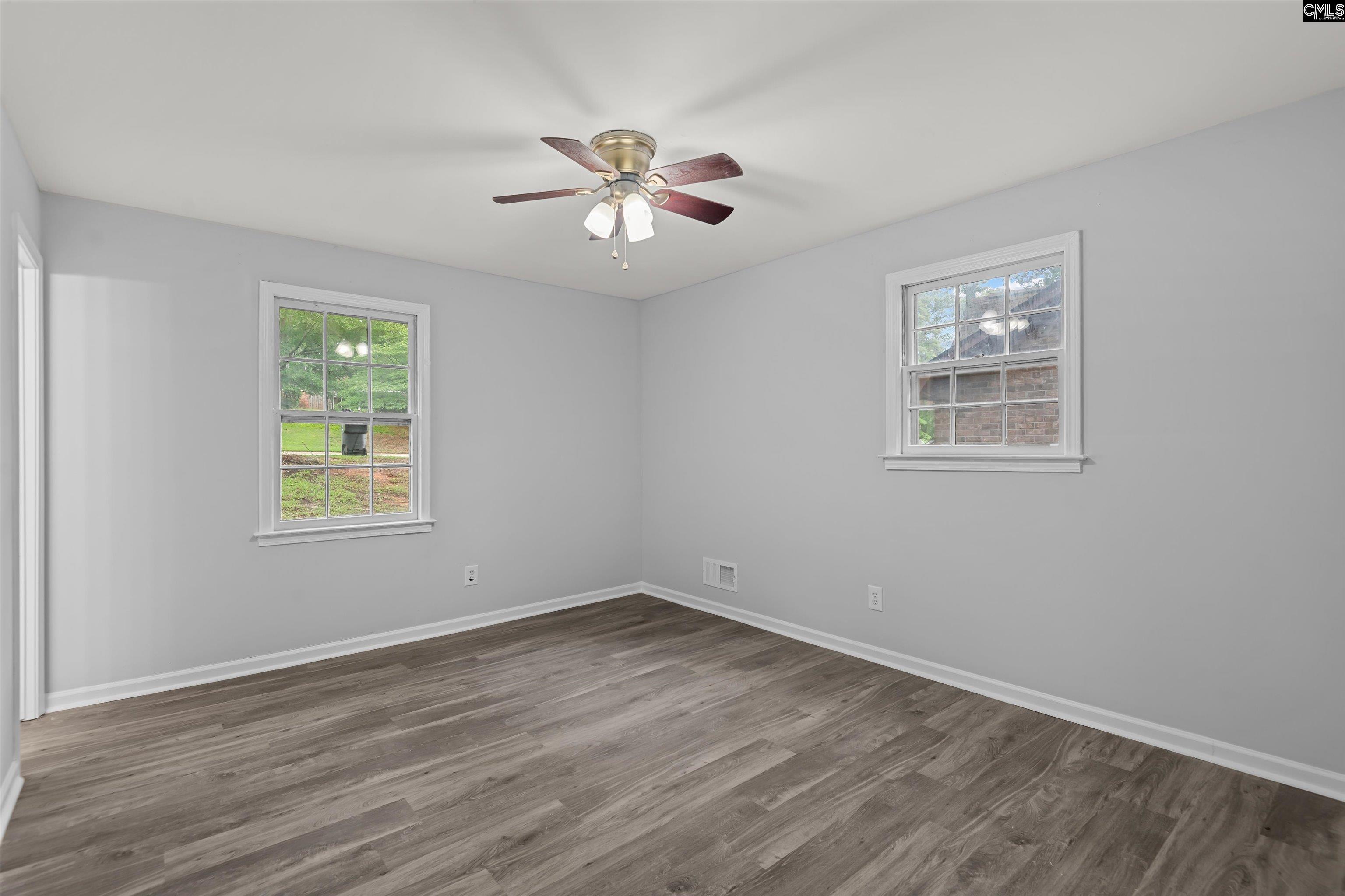 245 Piney Grove Road Columbia, SC 29210 - Photo 15 of 29 a view of an empty room with wooden floor and a window