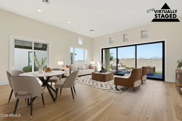 a view of an empty room with kitchen and a window