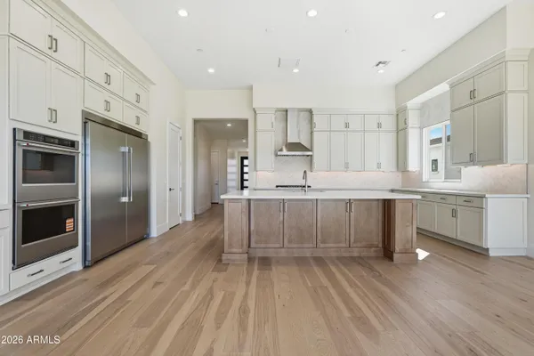 a kitchen with a sink stove and cabinets