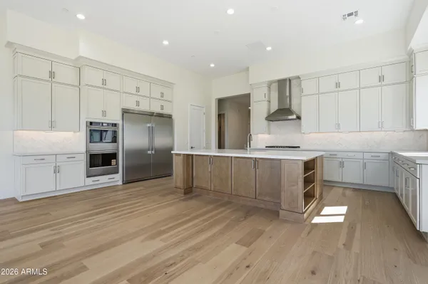 a kitchen with stainless steel appliances granite countertop a sink stove and cabinets