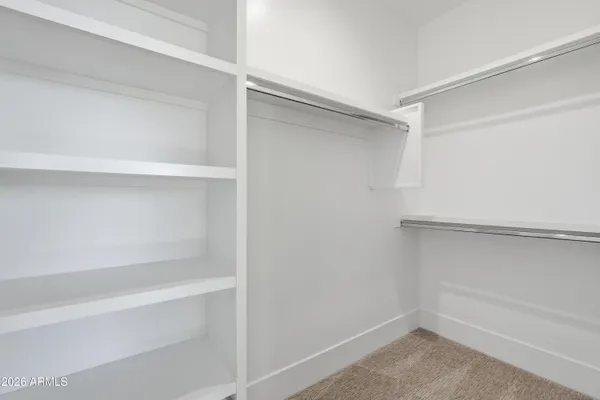 a kitchen with granite countertop white cabinets and sink