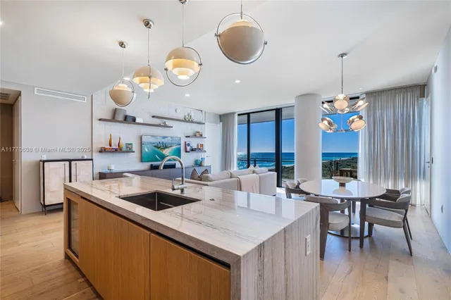 a kitchen with a table chairs and a chandelier