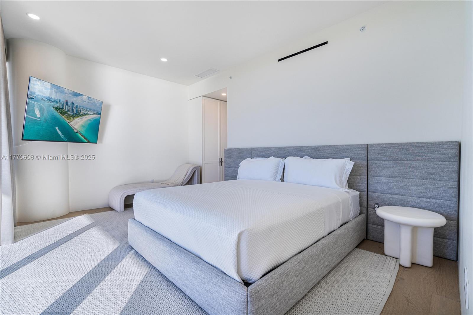 8701 Collins Avenue, Unit 804 Miami Beach, FL 33154 - Photo 15 of 25 a bed room with a bed and a couch