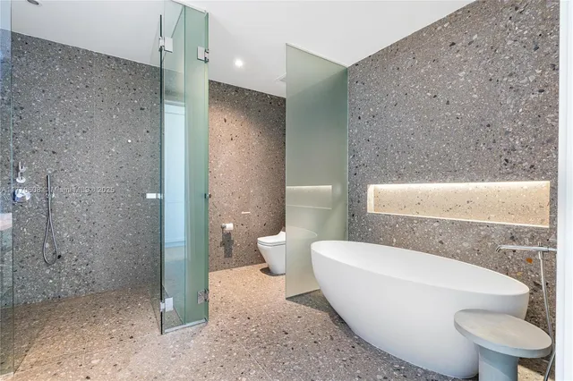 a bathroom with a toilet and a shower