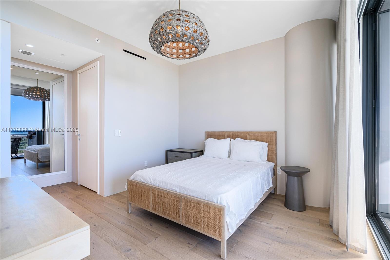 8701 Collins Avenue, Unit 804 Miami Beach, FL 33154 - Photo 22 of 25 a bedroom with a bed and a chandelier