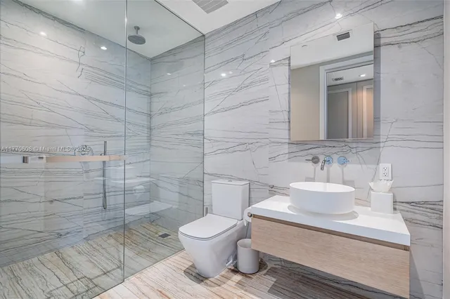 a bathroom with a toilet sink and shower