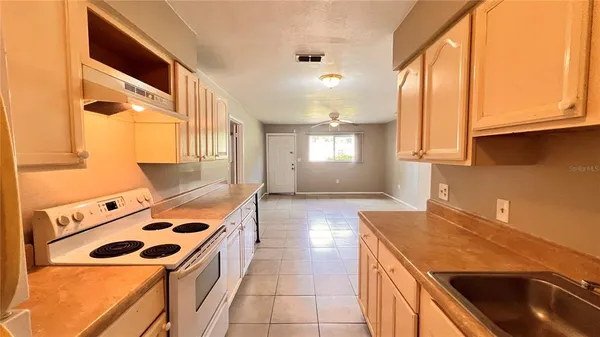 a kitchen with a stove window and cabinets