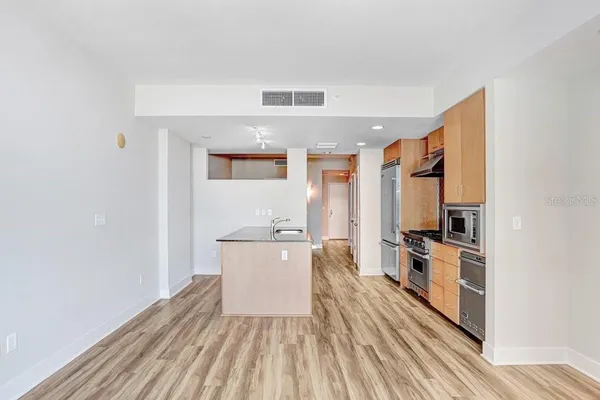 a kitchen with stainless steel appliances a refrigerator and a stove