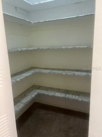 a view of an empty room with a fireplace