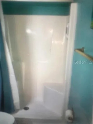 a view of backyard with a large window and plants