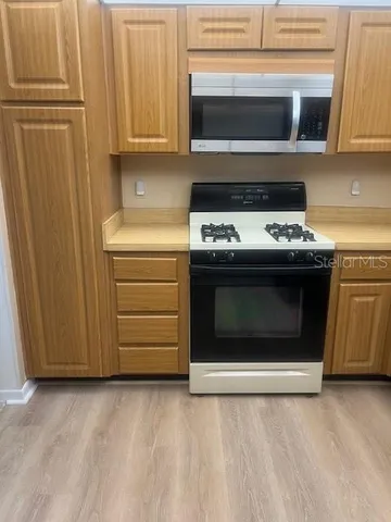 a stove top oven sitting inside of a kitchen