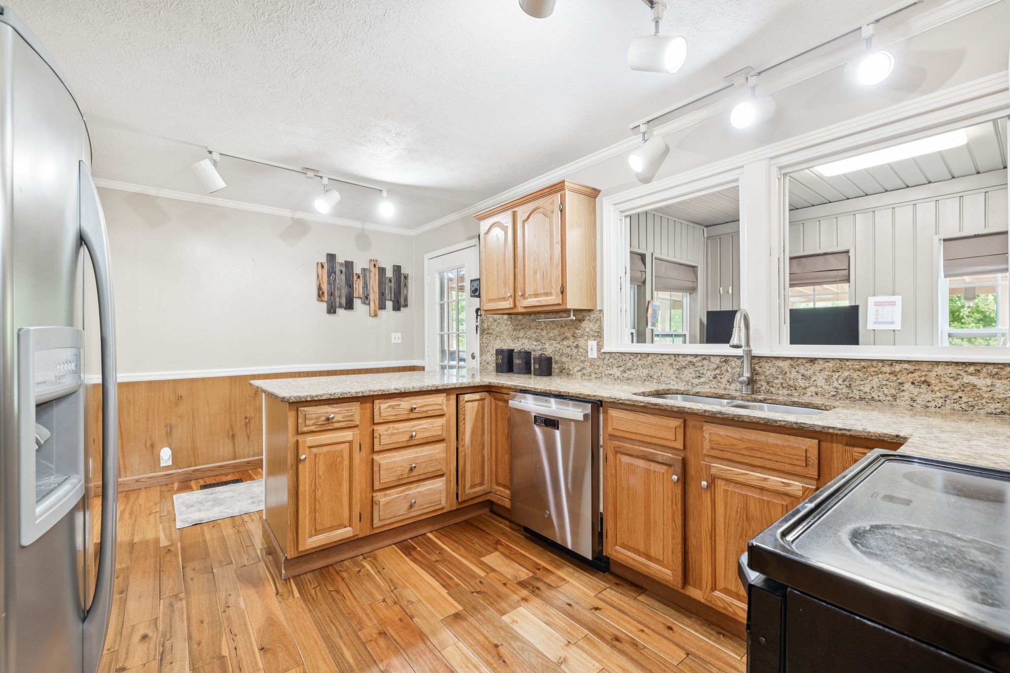 2151 Bakerville Road Waverly, TN 37185 - Photo 20 of 67 a large kitchen with granite countertop a sink dishwasher a stove and white cabinets with wooden floor