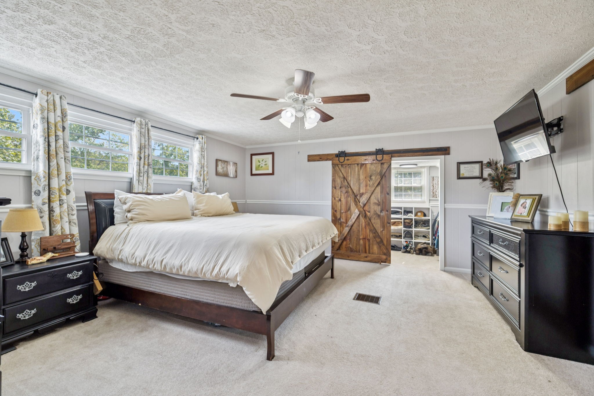 2151 Bakerville Road Waverly, TN 37185 - Photo 33 of 67 a spacious bedroom with a bed and dresser with mirror