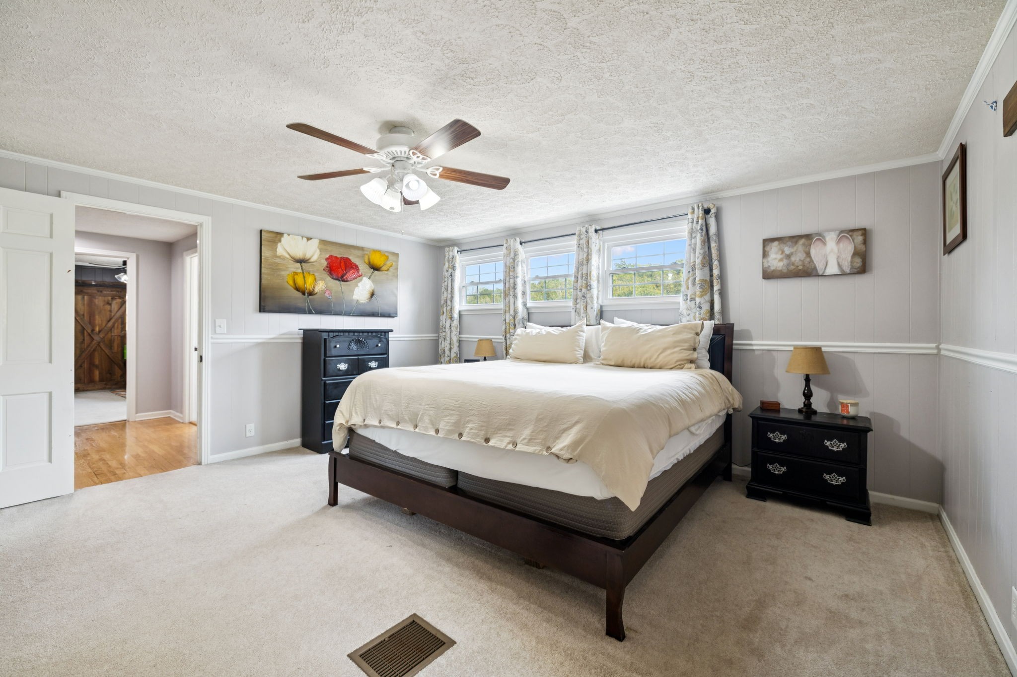 2151 Bakerville Road Waverly, TN 37185 - Photo 34 of 67 a spacious bedroom with a bed and a chandelier