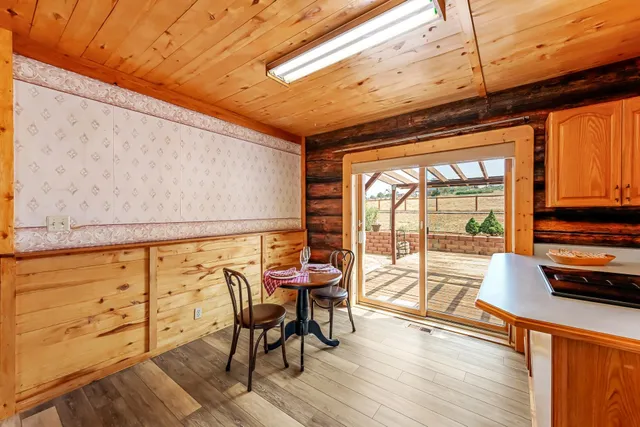 a view of a dining room with furniture next to a window