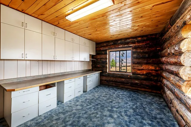 a kitchen with granite countertop white cabinets and window