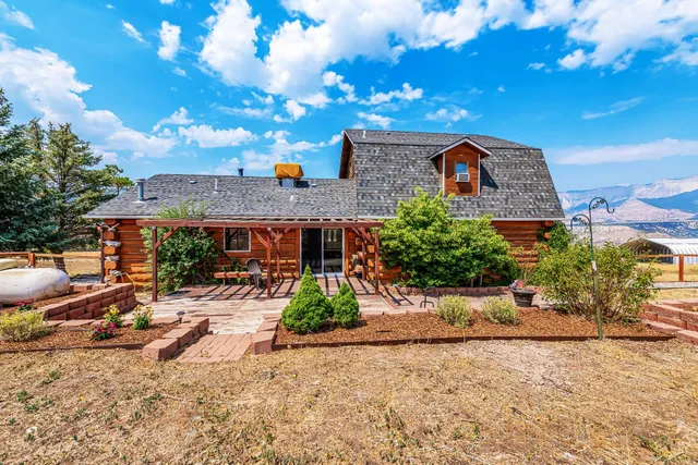 a front view of house with a garden