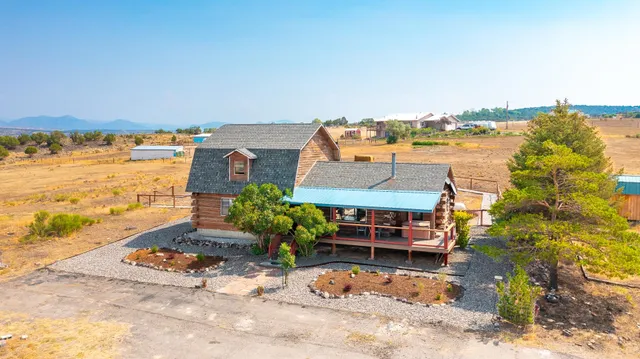 an aerial view of a house with a garden and mountain view