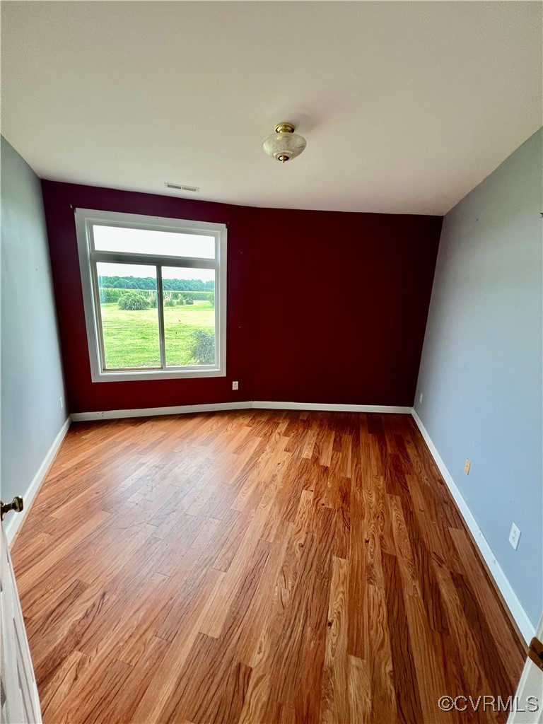 395 Kinsale Creek Road Kinsale, VA 22488 - Photo 15 of 41 an empty room with wooden floor and windows