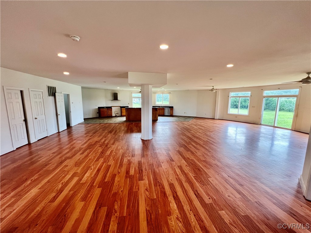 395 Kinsale Creek Road Kinsale, VA 22488 - Photo 9 of 41 a view of a big room with wooden floors and chairs
