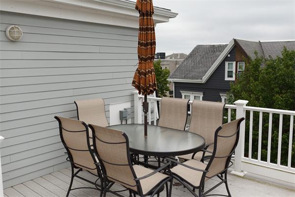 141-143 M Street, Unit 2 Boston, MA 02127 - Photo 15 of 15 a patio with table and chairs and potted plants