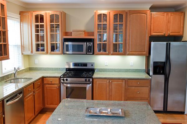 141-143 M Street, Unit 2 Boston, MA 02127 - Photo 2 of 15 a kitchen with stainless steel appliances granite countertop a stove sink and refrigerator