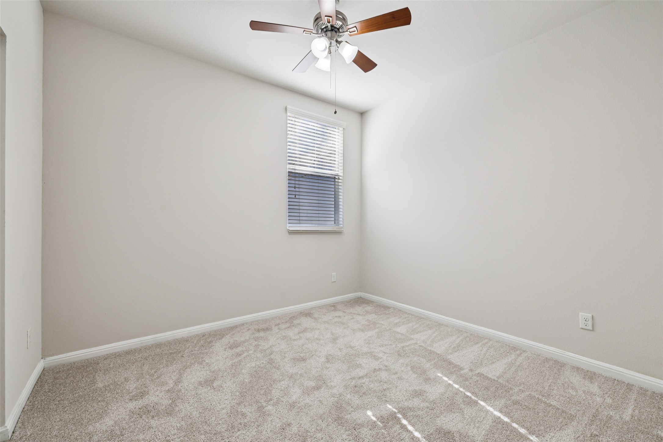 1524 Sanders Kyle, TX 78640 - Photo 23 of 37 Empty room with light colored carpet and ceiling fan