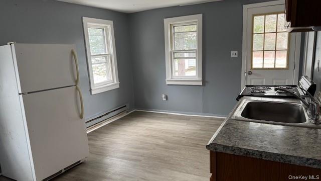 278 Cold Spring Road, Unit 4 Monticello, NY 12701 - Photo 3 of 9 a kitchen with granite countertop a sink stove and refrigerator